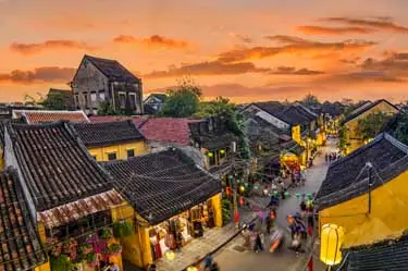 Hoi An Ancient Town at sunset, with lantern-lit streets and historic yellow facades, capturing the timeless charm of one of Vietnam’s best-preserved cultural heritage sites.