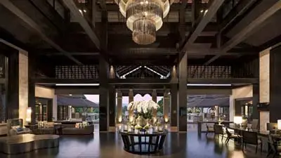 Lobby of Le Méridien Chiang Rai Resort, featuring contemporary Thai design, soaring ceilings, elegant chandeliers, and an open, airy layout overlooking lush surroundings.