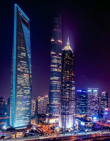Shanghai Pudong skyline at night featuring the Shanghai Tower, Jin Mao Tower, and Shanghai World Financial Center