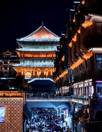 Crowded evening scene in Xi’an’s Muslim Quarter beneath the illuminated Drum Tower