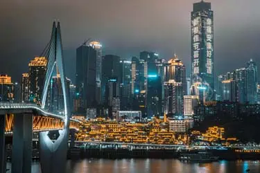 Chongqing skyline at night with the Yangtze River and illuminated bridges, showcasing the city’s dramatic riverside cityscape.