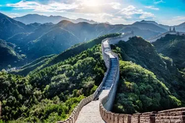 Great Wall of China winding across lush mountain ridges, highlighting one of the country’s most iconic scenic landmarks.