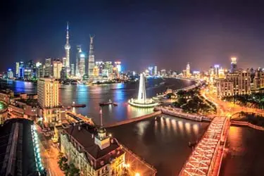 Shanghai skyline at night with the Huangpu River and illuminated city landmarks