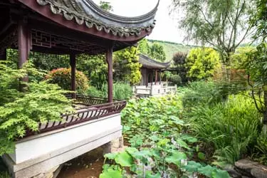 Yu Garden in Shanghai with classical pavilions, lush greenery, and tranquil ponds reflecting traditional Chinese garden design.