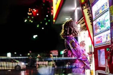 Modern nightlife moment in Kyoto with glowing vending machines and passing lights