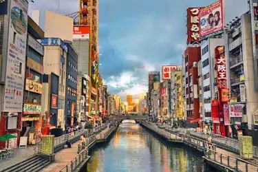 Vibrant Dotonbori district in Osaka lit by neon signs and reflected in the canal, Japan's culinary capital