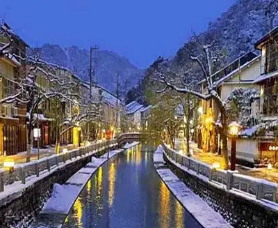 Snowy canal at night in Kinosaki Onsen, one of Japan’s most famous hot spring towns