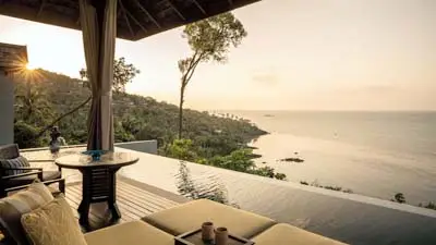 Infinity pool villa terrace at Four Seasons Resort Koh Samui, overlooking the Gulf of Thailand with serene ocean views, lush hillside surroundings, and sunset light.