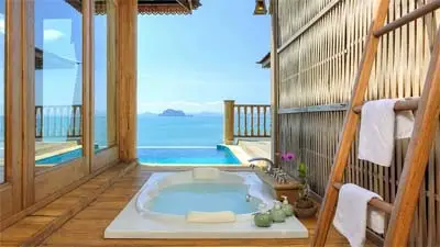 Private ocean-view bathtub at Santhiya Resort & Spa Koh Yao Yai, featuring natural wood design, open-air relaxation, and serene views of the Andaman Sea.