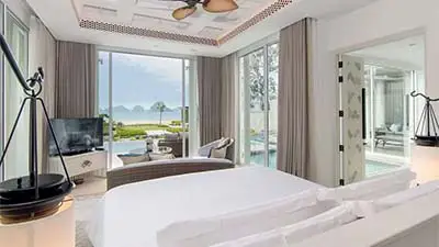 Ocean-view guest room at Banyan Tree Krabi, featuring contemporary Thai design, a plush king bed, and large windows overlooking the Andaman Sea in a serene coastal setting.