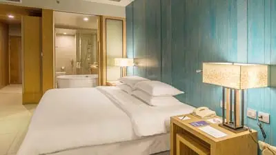 Guest room at Dusit Thani Krabi Beach Resort, featuring contemporary Thai décor, a plush king bed, and a bright, spacious layout near the beachfront.