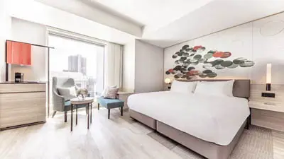 Contemporary hotel room at Centara Grand Osaka offering easy access to Osaka’s main districts