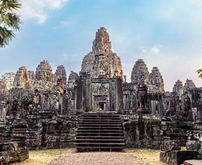 Ancient stone towers of Angkor Thom in Siem Reap, Cambodia, showcasing the intricate Khmer architecture and timeless grandeur of this UNESCO World Heritage site.