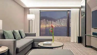 Guest room at New World Millennium Hong Kong, a luxury hotel offering convenient access to Victoria Harbour and city attractions.