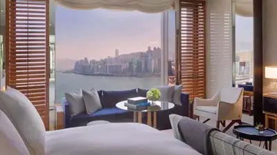 Guest room at Rosewood Hong Kong, a luxury hotel offering elegant accommodations with panoramic Victoria Harbour views.