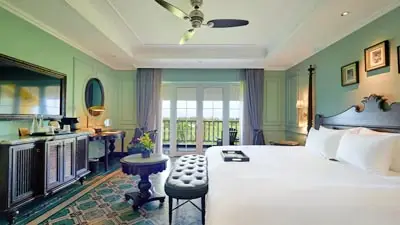 Elegant guest room at La Siesta Resort Hoi An featuring classic Vietnamese design, private balcony views, conveniently locatedd close to Hoi An Ancient Town and the riverfront.