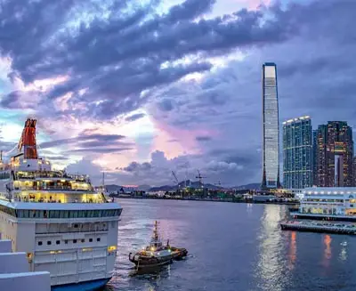Victoria Harbour at dusk with cruise ships and Hong Kong’s skyline, including the ICC tower