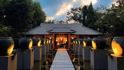 Serene entrance to Pilgrimage Village Resort & Spa in Hue, Vietnam, featuring traditional architecture and lantern-lit pathways that evoke tranquility and cultural charm.