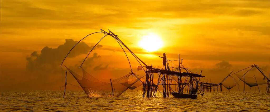 Fisherman net fishing at dusk in Southern Thailand
