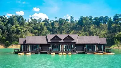500Rai Floating Resort on Cheow Lan Lake in Khao Sok National Park, Thailand, featuring luxury floating villas set on emerald-green water amid lush rainforest surroundings.