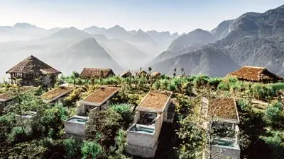 Topas Ecolodge in Sapa, Vietnam, featuring hillside bungalows with panoramic views of misty mountain ranges, offering a secluded eco-luxury retreat in the northern highlands.