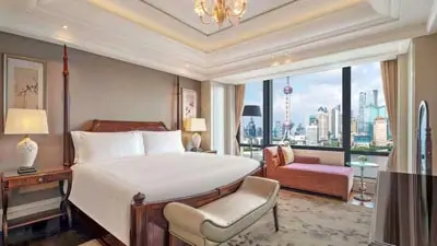 Refined guest room at Waldorf Astoria Shanghai, a luxury hotel overlooking the Huangpu River