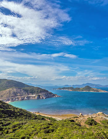 Panoramic coastal view of Nha Trang, Vietnam, featuring turquoise bays, rolling hills, and pristine beaches along the country’s scenic south-central shoreline.