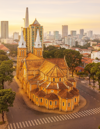Notre-Dame Cathedral Basilica of Saigon at sunrise in Ho Chi Minh City, a historic French colonial landmark set against the modern skyline with convenient access to the city’s central districts.