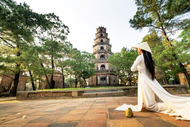 Girl Praying in front of Thien Mu pagoda, Hue Vietnam