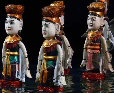 Traditional Vietnamese water puppets standing on water, depicting hand-painted folk characters used in classic water puppet theatre performances in Vietnam.