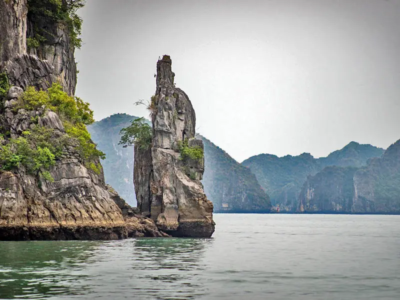 Limestone karst rock formations rising from the water in Halong Bay Vietnam—scenic cruising view for Halong Bay travel guide