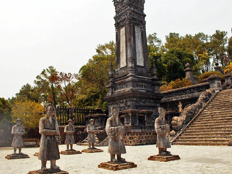 Stone guardian statues at Khai Dinh Tomb in Hue Vietnam with imperial architecture and terrace steps