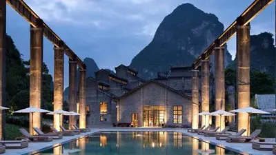 Stylish courtyard pool at Yangshuo Sugar House, a luxury hotel set against Yangshuo’s dramatic karst mountains
