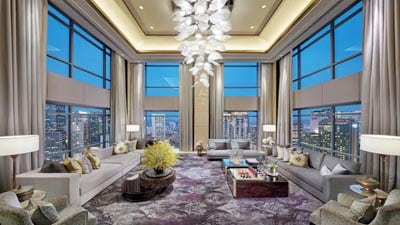 Luxury suite living room at Mandarin Oriental Kuala Lumpur with floor-to-ceiling windows overlooking the Petronas Twin Towers skyline, Malaysia