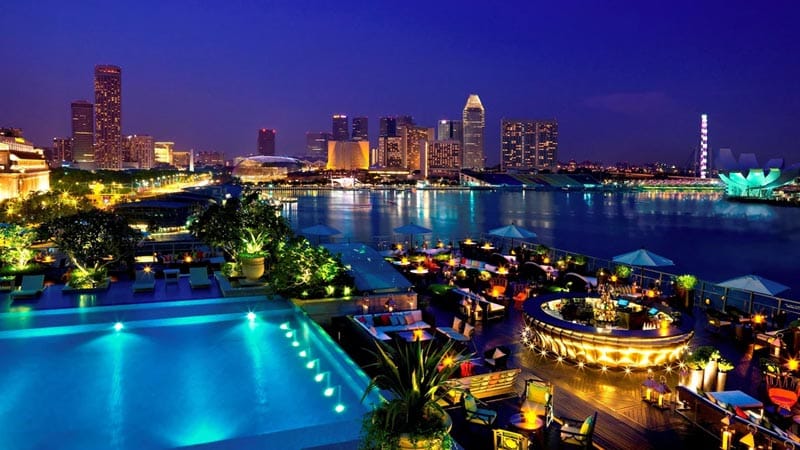 Skyline view of Singapore from The Fullerton Bay Hotel, featuring Marina Bay’s illuminated waterfront, infinity pool, and city lights at night.