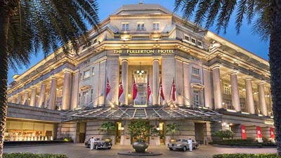 The Fullerton Hotel Singapore’s landmark façade glowing in evening light, reflecting its legacy as a treasured heritage building