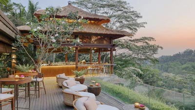 Luxury riverside terrace at Mandapa a Ritz-Carlton Reserve in Ubud featuring open-air lounge seating and sweeping jungle valley views