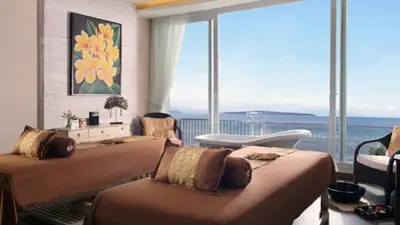 Ocean-view spa treatment room at Plataran Menjangan Resort and Spa in West Bali, featuring floor-to-ceiling windows, tranquil sea horizon, and refined luxury wellness setting