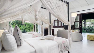 Luxury beachfront villa at Samanea Beach Resort Kep featuring open-plan design, canopy bed, and tropical garden views
