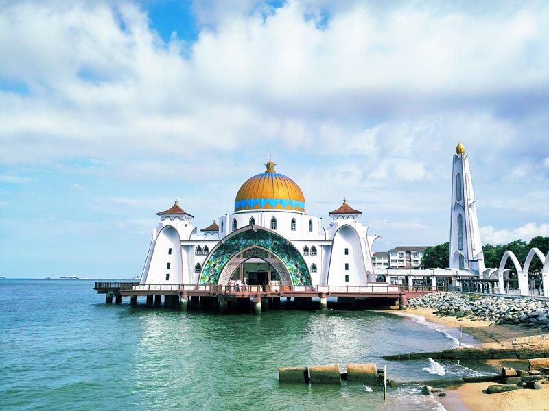 Melaka Straits Mosque overlooking the tranquil Malacca Strait, a serene waterfront landmark for culturally immersive coastal journeys