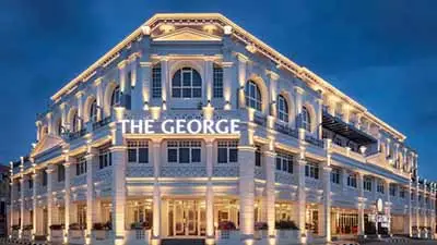 The George Hotel in George Town, Penang, Malaysia, featuring illuminated colonial-style façade at dusk in the UNESCO heritage district