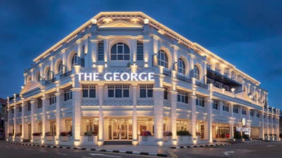 Restored heritage building housing The George Penang, featuring grand symmetrical architecture and premium urban accommodations