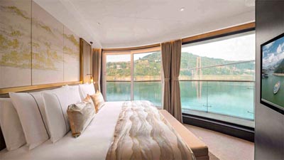 Luxury cabin aboard the Yangtze Century Oasis cruise, offering panoramic river views along the Yangtze River.