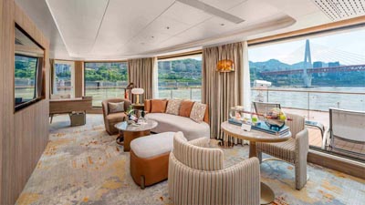 Spacious suite aboard the Yangtze Century Voyage cruise, featuring elegant interiors and panoramic Yangtze River views.