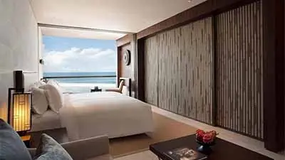 Deluxe oceanfront suite at Alila Villas Seminyak with open-plan living, and panoramic Indian Ocean views