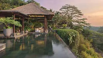 Infinity pool at Mandapa, a Ritz-Carlton Reserve in Ubud, Bali, overlooking lush river valley landscapes and offering an exclusive luxury retreat in the heart of nature.