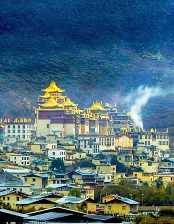 Songzanlin Monastery overlooking Shangri-La town, showcasing Tibetan Buddhist architecture set against Yunnan’s highland landscape.