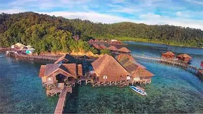 Gayana Marine Resort in Sabah, Malaysia, featuring overwater villas on stilts above clear turquoise waters near Kota Kinabalu