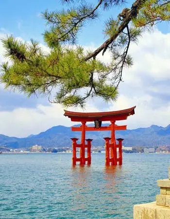 Torii gate standing in the sea at Itsukushima Shrine on Miyajima Island