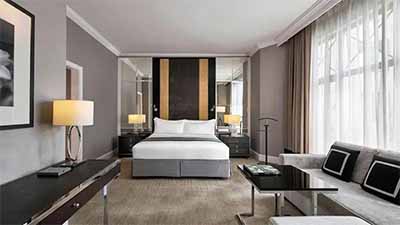 Elegant guest room at The Ritz-Carlton Kuala Lumpur, Malaysia, featuring modern décor, king bed, and refined luxury interiors